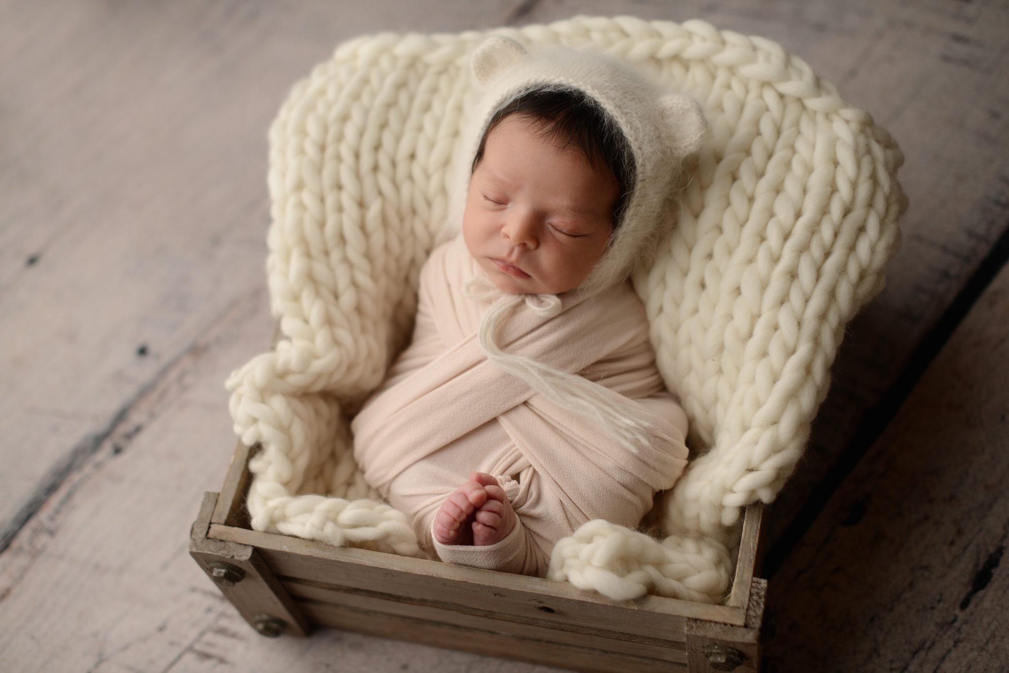 Queens newborn studio portrait of baby girl in cream wrap