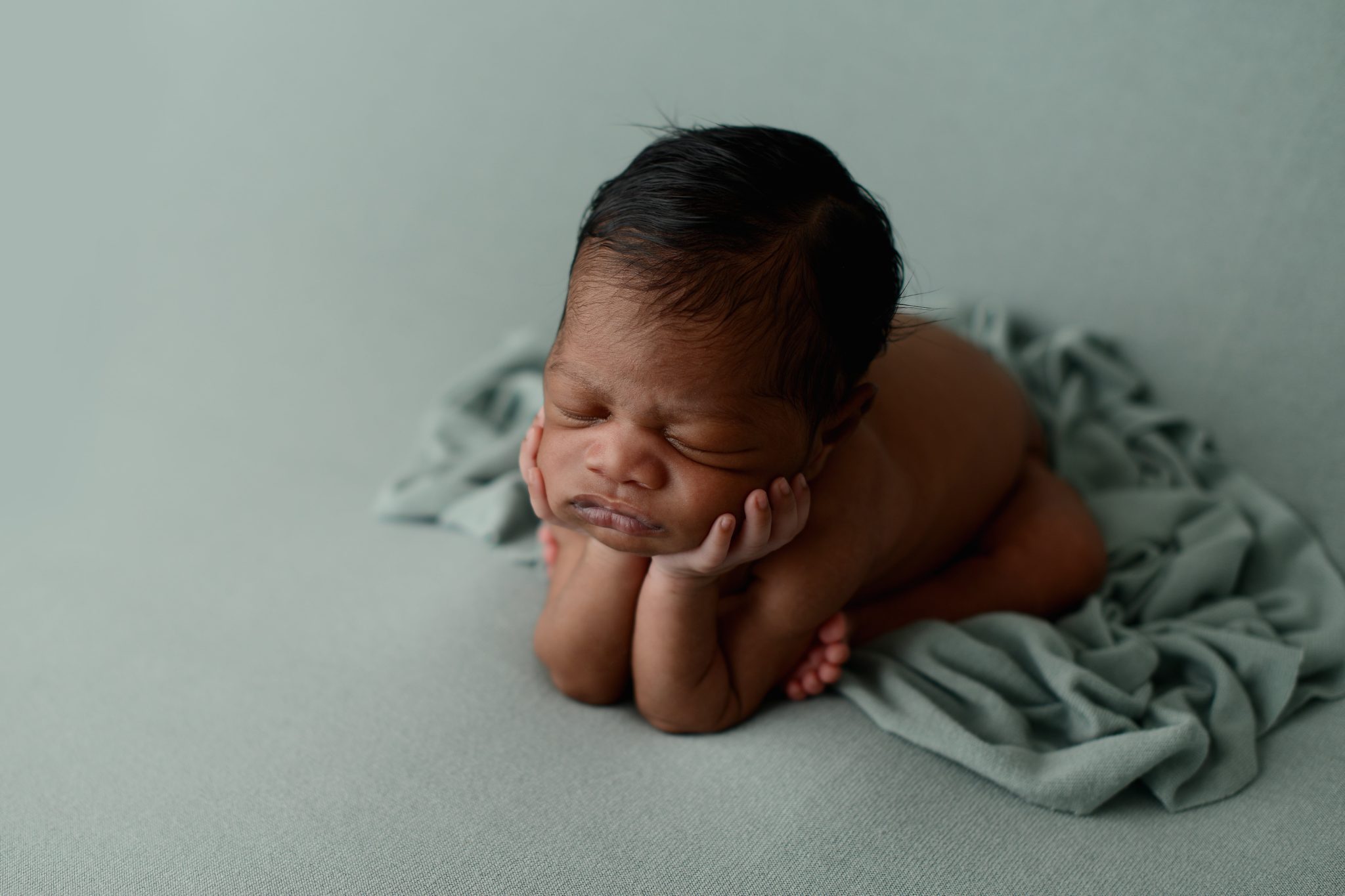 Tips for Great Newborn Photos: African American Baby on green backdrop