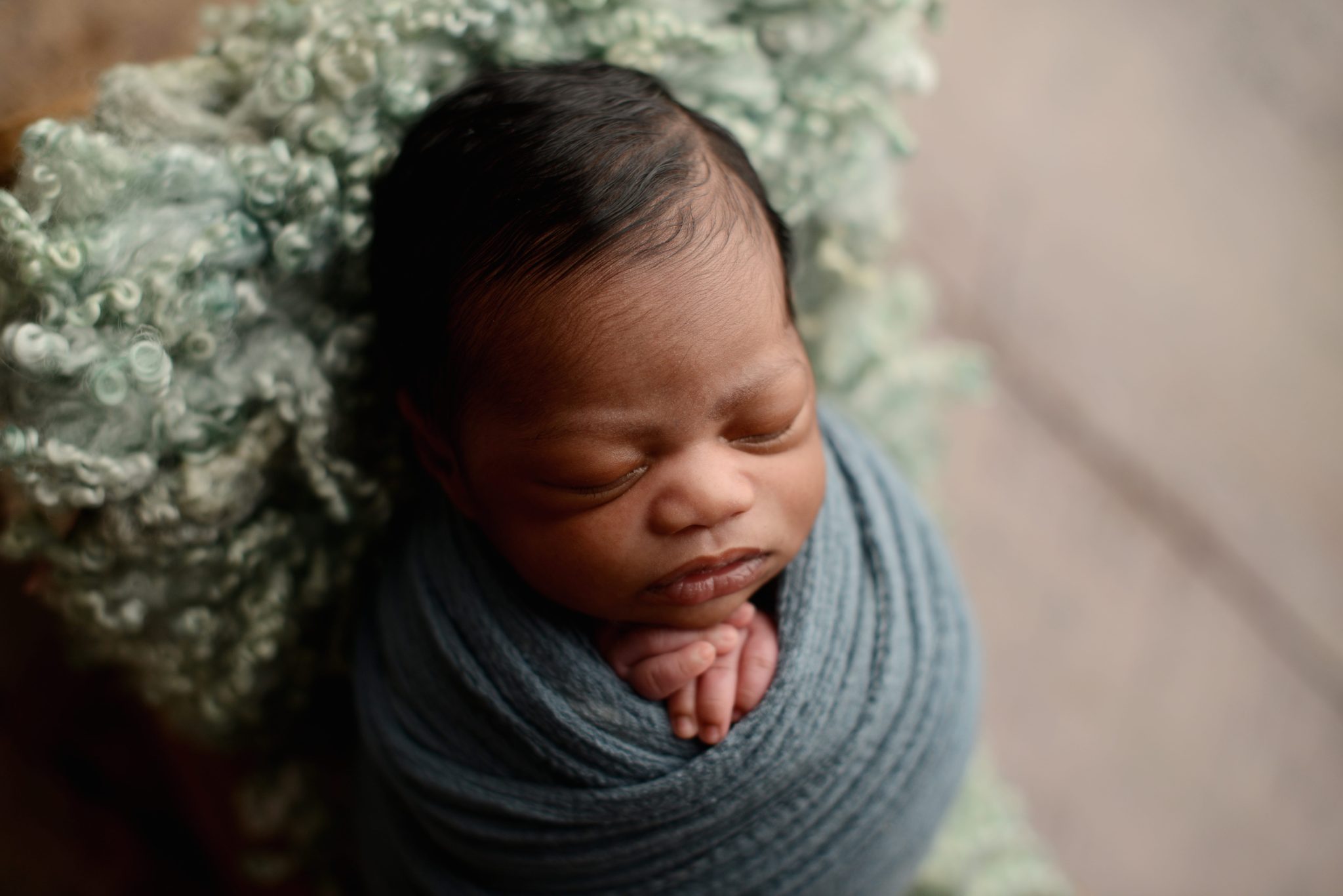 Tips for Great Newborn Photos: African American Baby on green backdrop